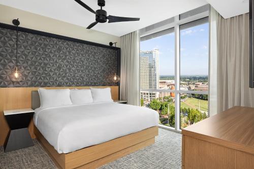 a bedroom with a bed and a large window at Wyndham Margaritaville Resort 2BR Apartment with Resort Access in Atlanta