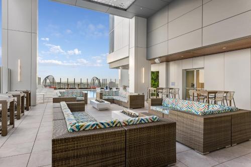 an outdoor patio with wicker chairs and tables at Wyndham Margaritaville Resort 2BR Apartment with Resort Access in Atlanta