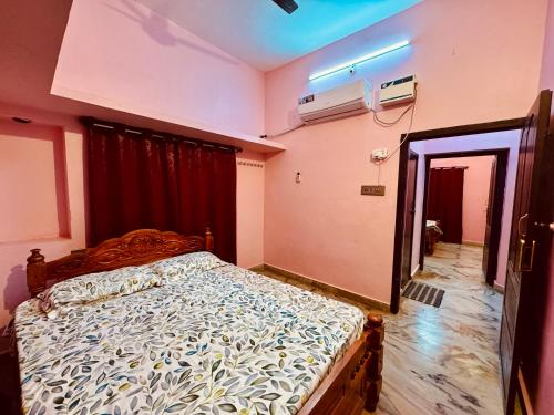 a bedroom with a large bed in a room at Phoenix Holiday Home in Kanyakumari