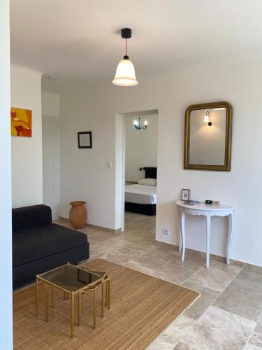 a living room with a couch and a table at Rez-de-villa dans le calme in Draguignan