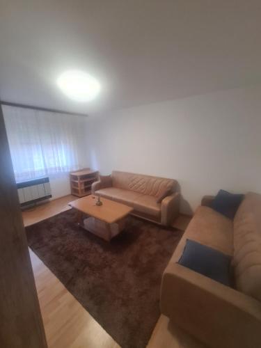 a living room with a couch and a coffee table at Stan Bjelave in Sarajevo
