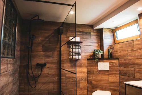 a shower stall in a bathroom with wooden walls at Einfach bei uns in Fresach