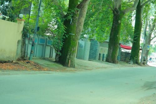 a street with trees on the side of a road at Golf View Lodges in Abbottabad