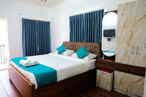 a bedroom with a bed with a mirror and a sink at Cheerful Chalet in Kodaikānāl