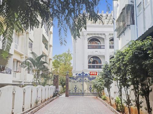 a gate in front of a white building at Super Hotel O Alpine Glow Crest in Hyderabad