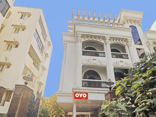 a white building with a yes sign in front of it at Super Hotel O Alpine Glow Crest in Hyderabad