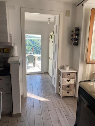a kitchen with a door leading to a patio at La Casetta di Nico in Beverone
