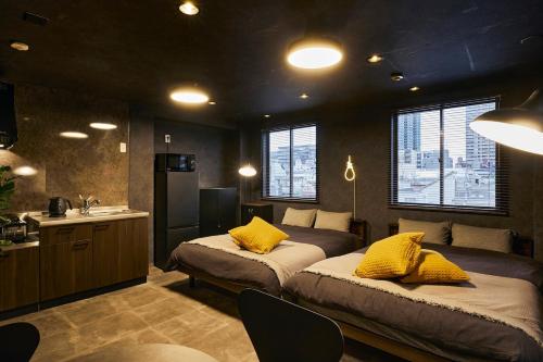 a bedroom with two beds with yellow pillows at Hotel-Mercurius-Azabujuban-RB in Tokyo