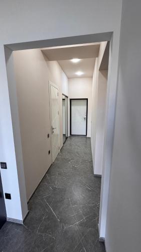 an empty hallway in a building with white walls at Райский уголок in Sumqayyt