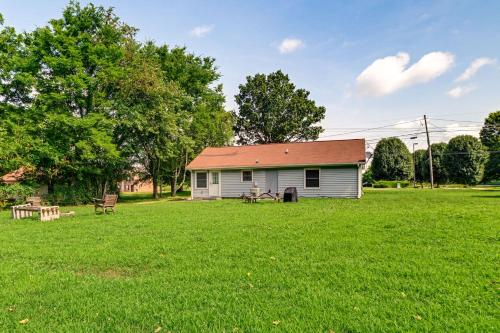 a small house in a field with a grass yard at half Mi to Fort Campbell State Line Retreat in Oak Grove
