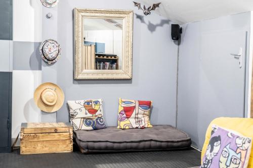 a room with a couch and a mirror at Gite Amélie, Sauna, Spa au coeur des Vosges in Housseras