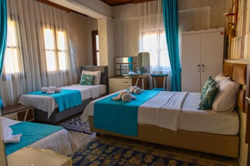 a bedroom with two beds with blue and white at Grand Erken Hotel in Antalya