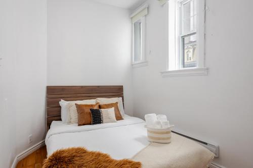 a bedroom with two beds and a window at Premium Location Stylish 3BR downtown Montreal in Montréal