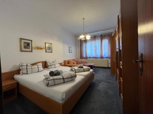 a hotel room with a large bed and a couch at Aparthotel Mariazellerhof in Sankt Pölten