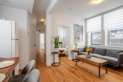 a living room with a couch and a table at Premium Location Stylish 3BR downtown Montreal in Montréal