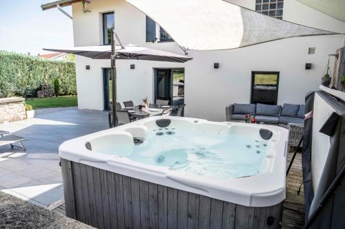 a hot tub in the backyard of a house at Gite Amélie, Sauna, Spa au coeur des Vosges in Housseras