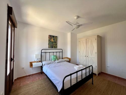 a bedroom with a bed and a ceiling fan at Casa Pueblo Overlooking the Village of Lubrín! in Lubrín