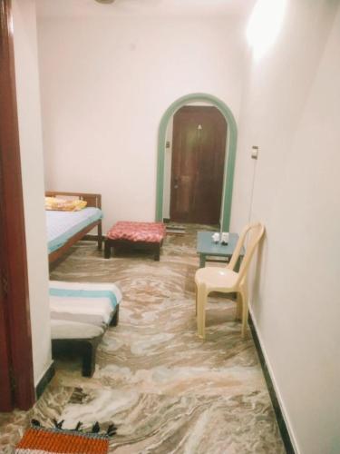 a room with a flooded floor with a couch and a chair at Villa Butterfly Studio in Pondicherry