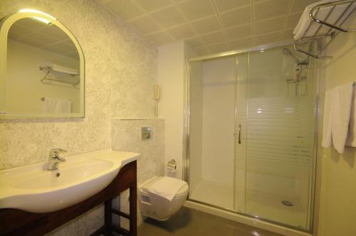 a bathroom with a sink and a shower and a toilet at Pasa Garden Beach in Marmaris