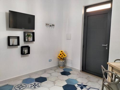 a room with a door and a vase of flowers at Casa vacanze Acquamarina in Portopalo