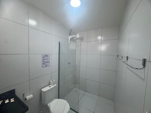a white bathroom with a shower and a toilet at BSH FLATS - Melhor custo benefício in Campina Grande