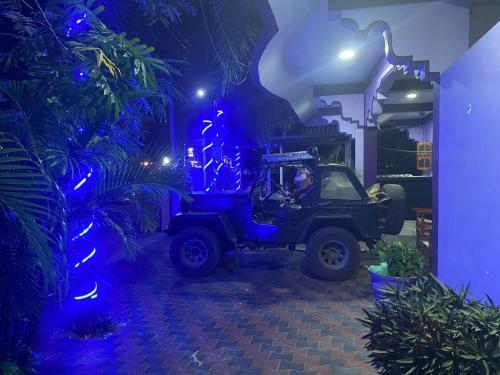 a jeep parked in a room with blue lights at SNP Star Guest House in Trincomalee