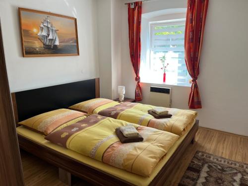 a bedroom with two beds and a window at Apartmány Merkel in Broumov