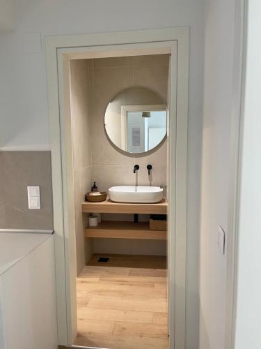 a bathroom with a sink and a mirror at Olea Blue in Skiathos Town