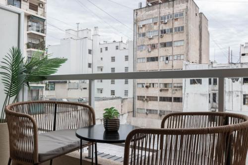 a balcony with a table and two chairs and a window at Fliphaus Moreno 550 'B' Loft with Pool in Plaza de Mayo in Buenos Aires