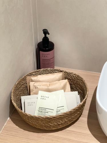 a basket of towels and a bottle of soap at Olea Blue in Skiathos Town