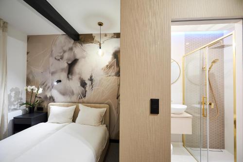 a bedroom with a white bed and a bathroom at Villa Scolia in Niechorze