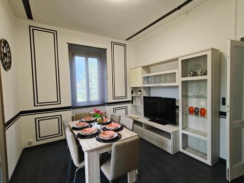 a living room with a table with plates on it at Villa WOLF - A 1919 original Swiss Villa with Garden near Como in Balerna