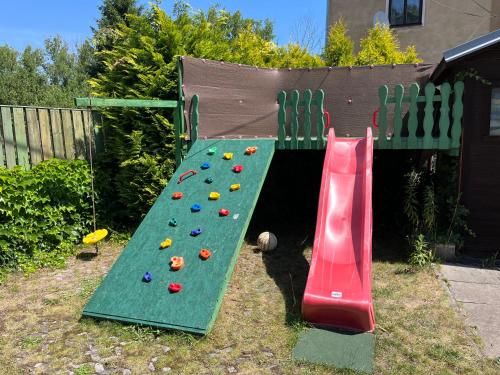 a playground with a slide and a climbing wall at Apartmány Merkel in Broumov