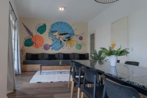 a living room with a table and a couch at Fliphaus Niceto Vega 4900 - 3 Bd Event & Party Friendly in Buenos Aires