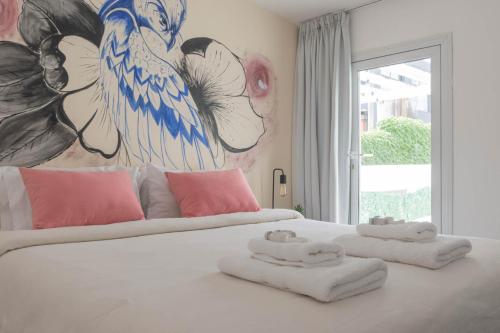 a large white bed with two towels on top of it at Fliphaus Niceto Vega 4900 - 3 Bd Event & Party Friendly in Buenos Aires