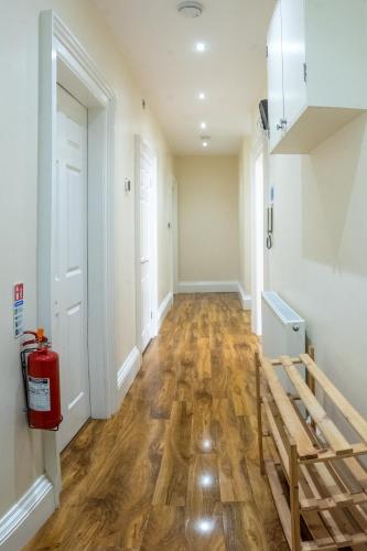 an empty hallway with a fire hydrant in a house at 3 Bedroom Apartment with castle views in Edinburgh