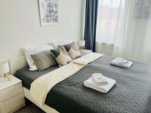 a bedroom with a bed with two towels on it at Mythos Hotel Oranienburg in Oranienburg
