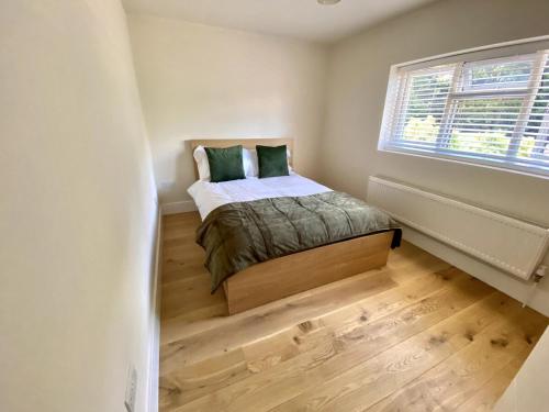 une petite chambre avec un lit et une fenêtre dans l'établissement Luxury 5 Bedrooms House in Milton Keynes, à Milton Keynes