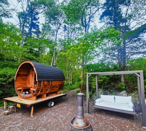a small wooden boat on a trailer with a couch at Sunken Escapes Glamping Unit #2 in New Minas