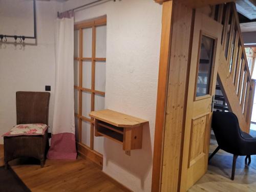 a room with a wooden door and a stair case at Landhaus Am Arzbach in Bad Tölz