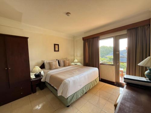 a bedroom with a large bed and a large window at Private Apartment 6503 at the Jayakarta Residence in Seminyak
