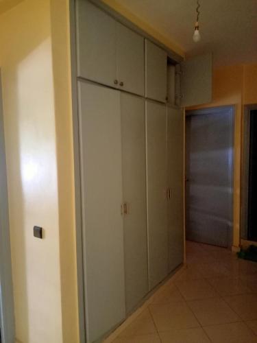 a room with white cabinets and a hallway at Casa sabir in Temara