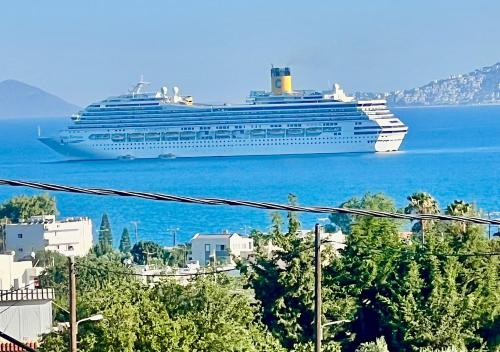 a cruise ship in the water with a city at Greek House Tatiana in Kos Town