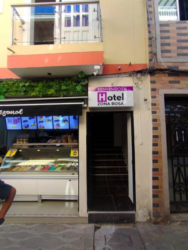 a store with a sign on the front of a building at Hotel ZONA ROSA MARINILLA in Marinilla
