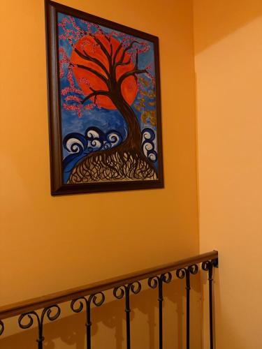 a painting of a tree on a wall at ART hotel MAXIM in Frýdek-Místek