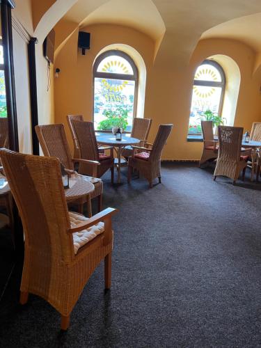 a waiting room with tables and chairs and windows at ART hotel MAXIM in Frýdek-Místek