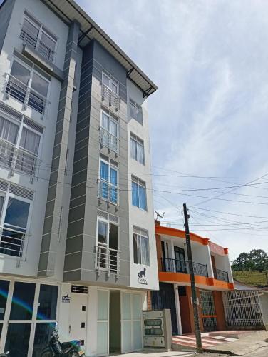 a building with a motorcycle parked in front of it at Tayra Living Suites in Mocoa