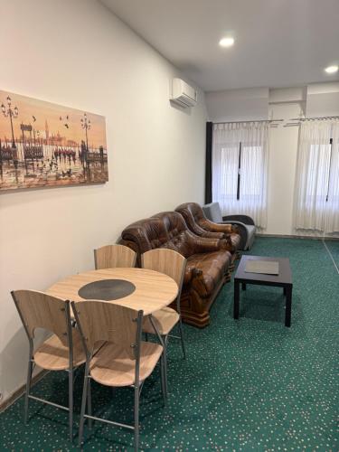 a living room with a couch and a table and chairs at ART hotel MAXIM in Frýdek-Místek