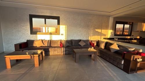 a living room with a couch and a table at Villa Kazim in Berkawe
