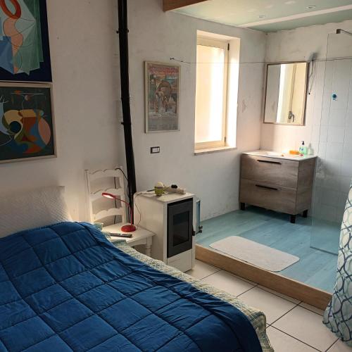 a bedroom with a bed and a bathroom with a sink at Casasvedese agriturismo in Marina